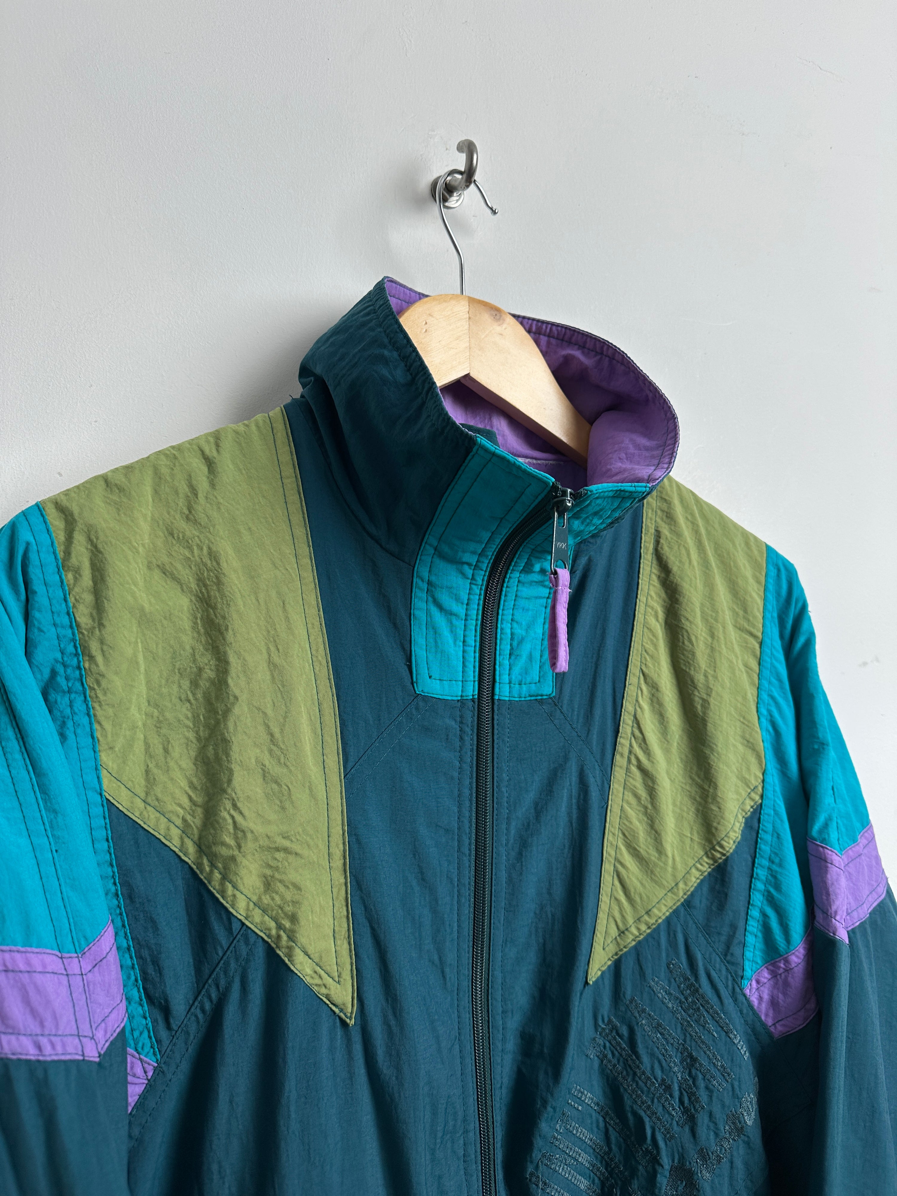 INTL windbreaker with blue and green patchwork pattern