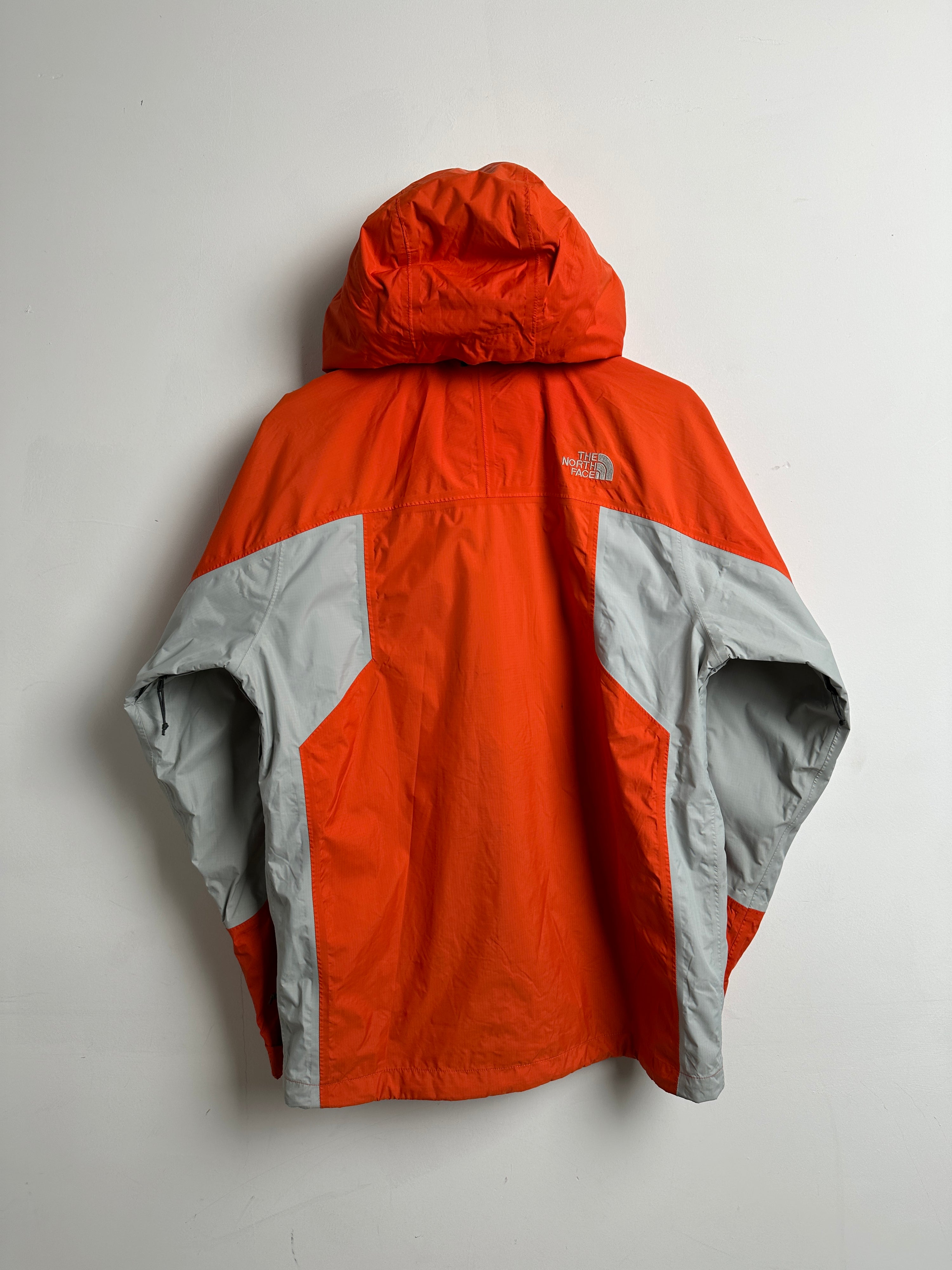 The North Face wind breaker in orange in grey