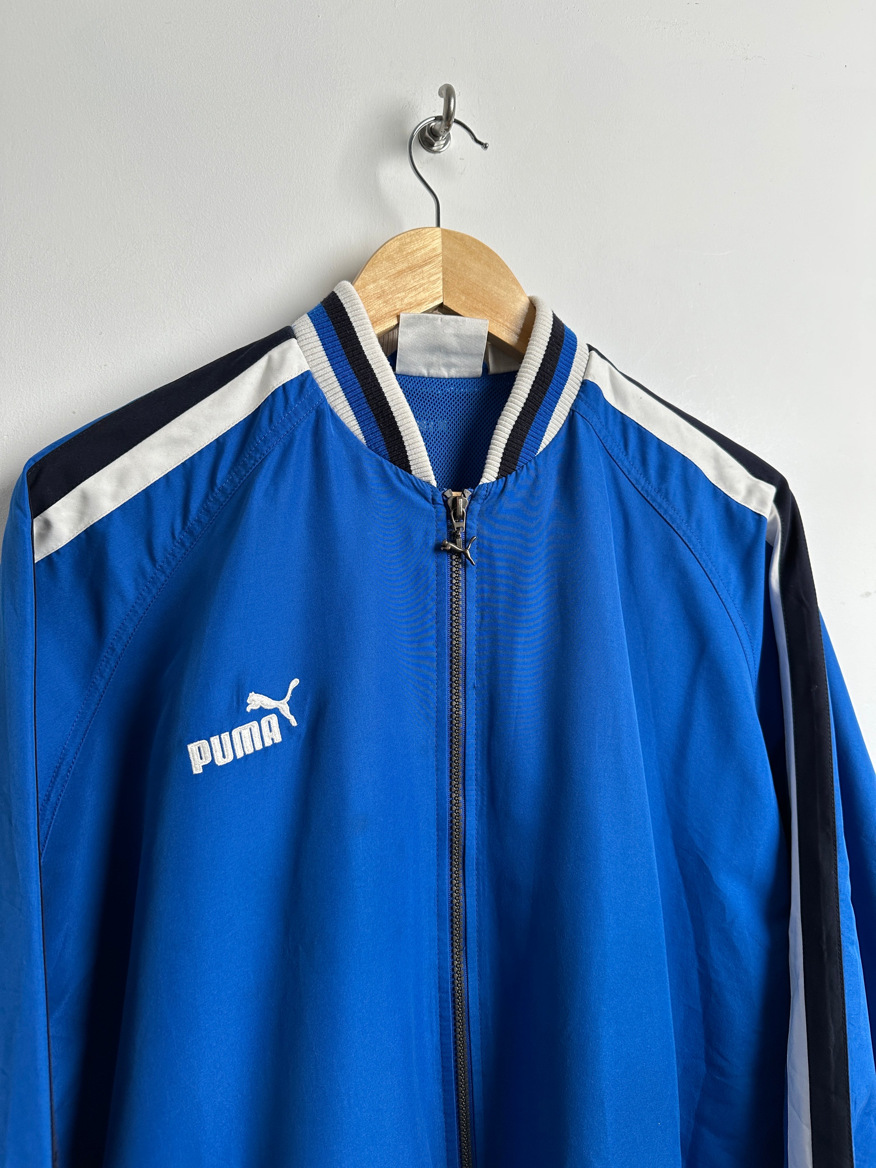 PUMA 90s windbreaker zip up in blue with black and white stripes