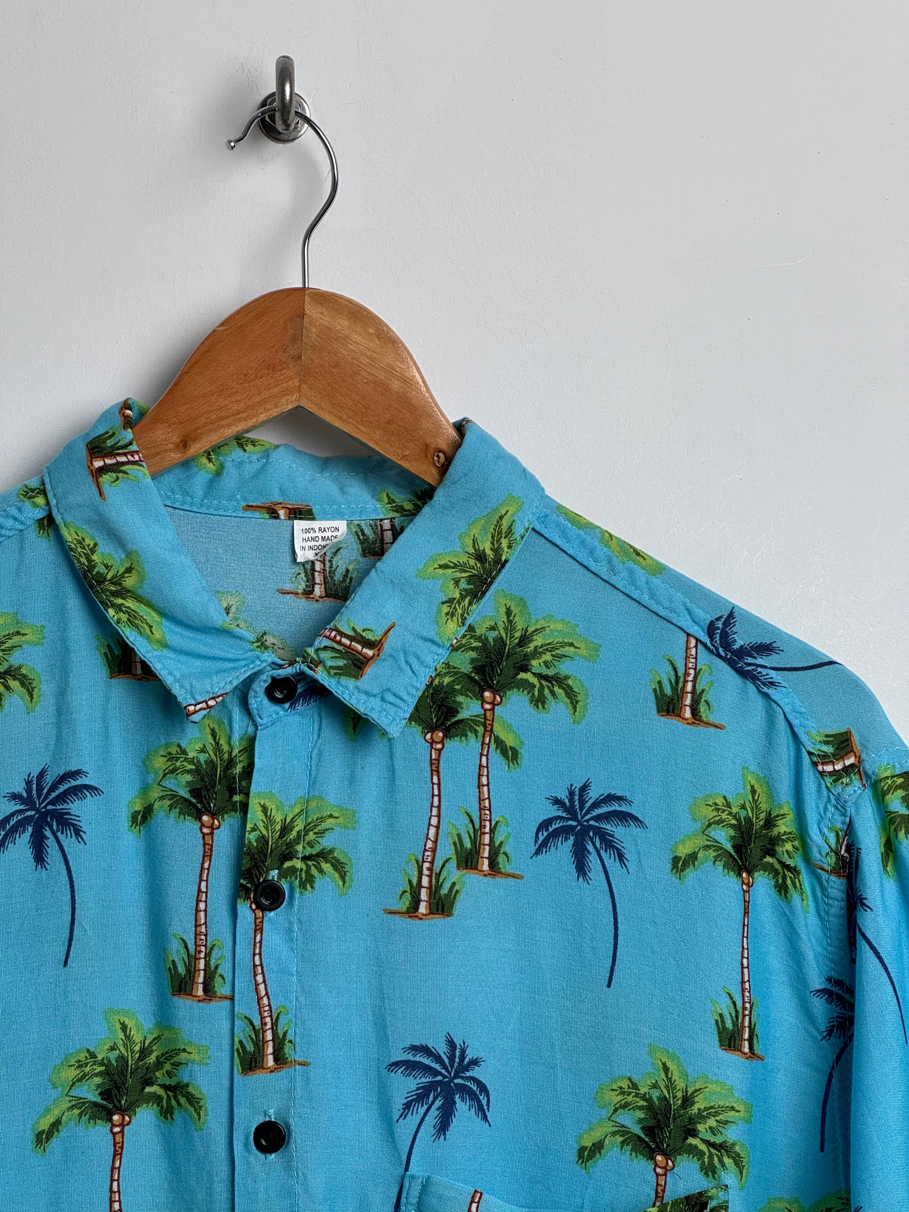 Vintage 100% Rayon short-sleeve shirt in blue with palm tree print